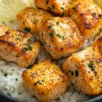 Close-up of crispy, golden-brown Air Fryer Salmon Bites served on a plate. The tender, flaky salmon is coated in a flavorful seasoning and crunchy